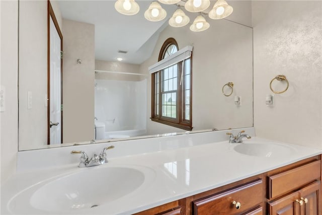 full bathroom featuring double vanity, toilet, visible vents, and a sink