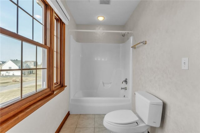 full bathroom with tile patterned flooring, shower / washtub combination, toilet, and baseboards