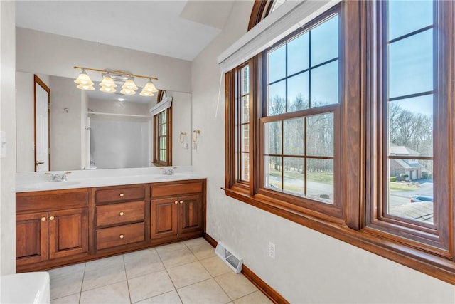 full bath featuring plenty of natural light, visible vents, and a sink