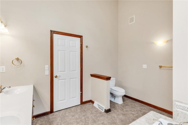 full bathroom featuring visible vents, baseboards, toilet, tile patterned floors, and a sink