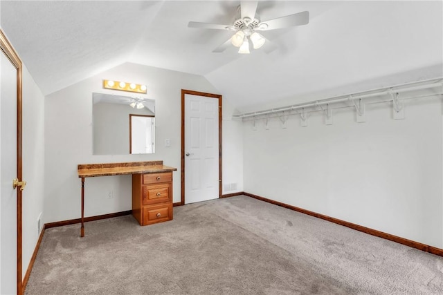 unfurnished bedroom with light colored carpet, baseboards, and lofted ceiling