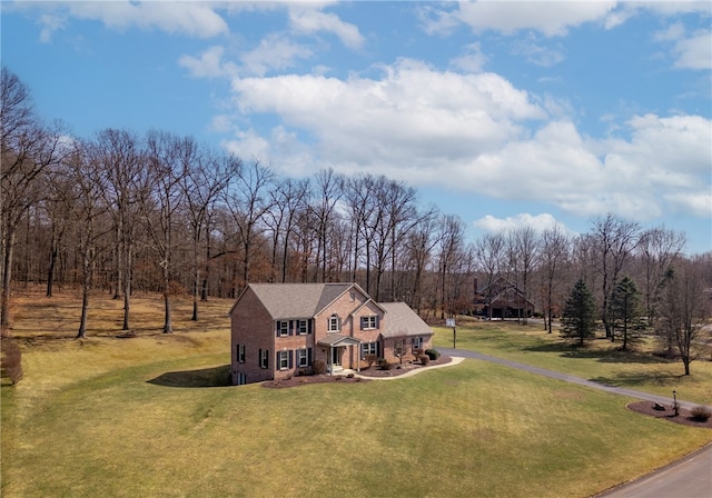 view of front of home with aphalt driveway, a gambrel roof, a front lawn, and a shingled roof