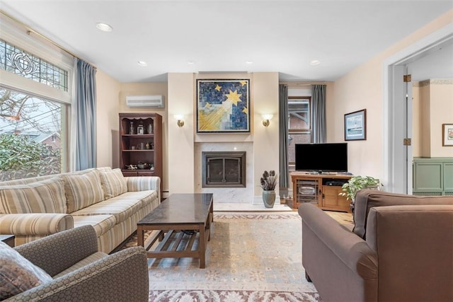 living area featuring a high end fireplace, recessed lighting, and a wall mounted AC