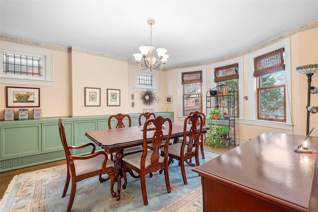 dining room with light wood-style flooring and a chandelier