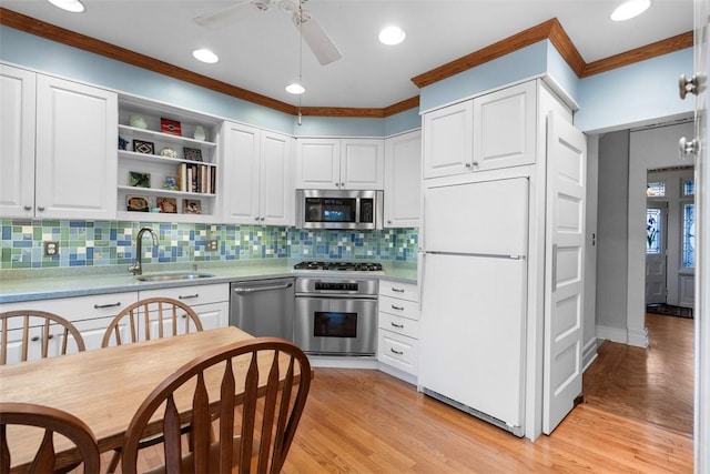 kitchen featuring a sink, light countertops, ceiling fan, and stainless steel appliances