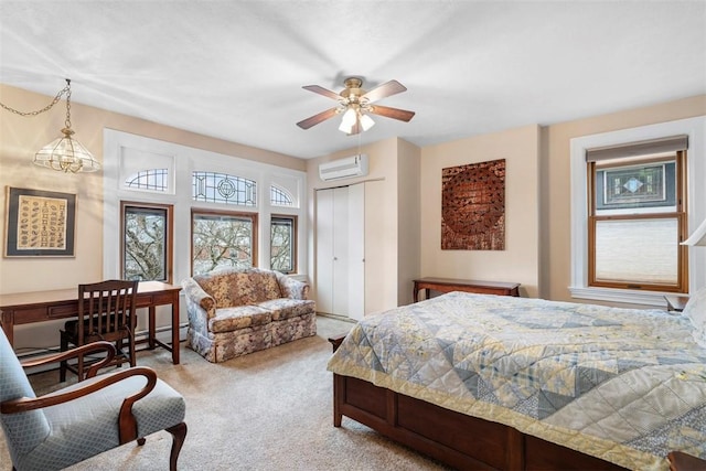 carpeted bedroom with a wall mounted air conditioner and ceiling fan