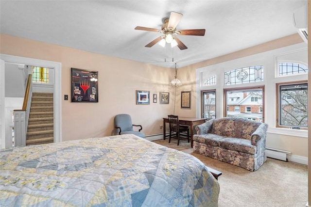 bedroom with carpet flooring, ceiling fan, baseboards, and a baseboard radiator