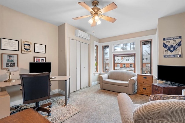 office area featuring baseboards, light colored carpet, an AC wall unit, and a ceiling fan