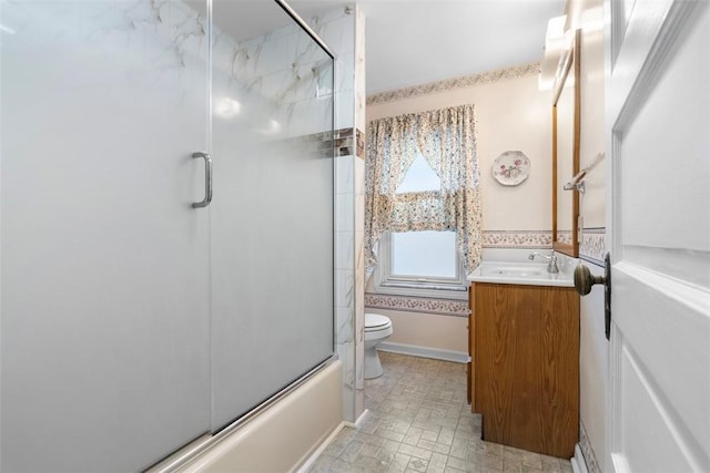 full bathroom featuring vanity, toilet, and shower / bath combination with glass door