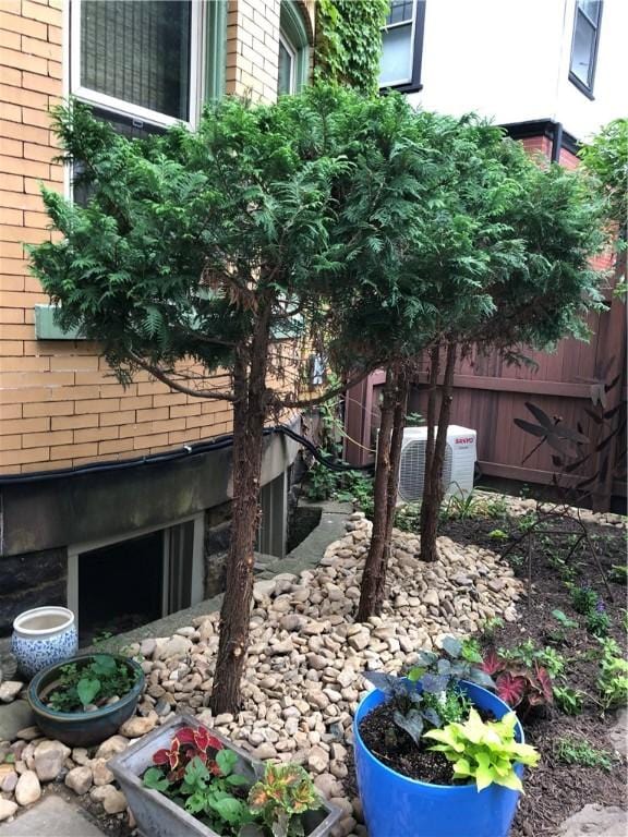 view of yard featuring cooling unit and fence