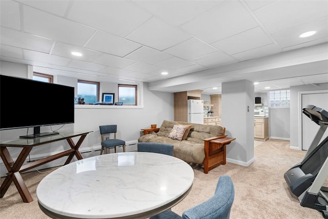 living area with recessed lighting, baseboards, and light carpet