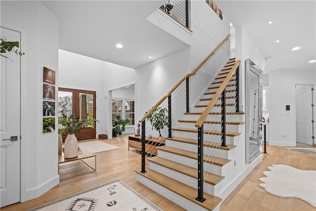 entrance foyer with stairway, recessed lighting, a high ceiling, and light wood-style floors