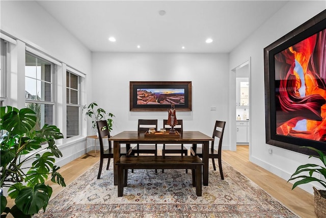 dining space featuring recessed lighting, baseboards, and light wood-style floors