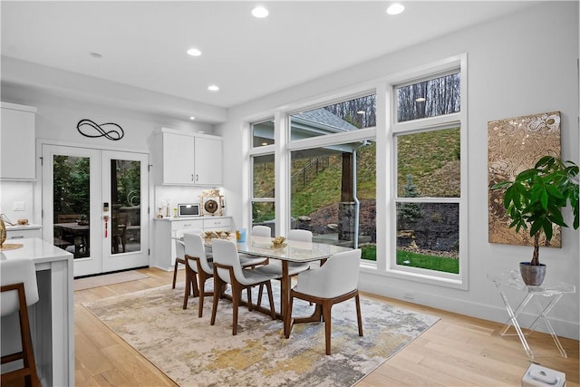 dining area with recessed lighting, french doors, baseboards, and light wood-style flooring