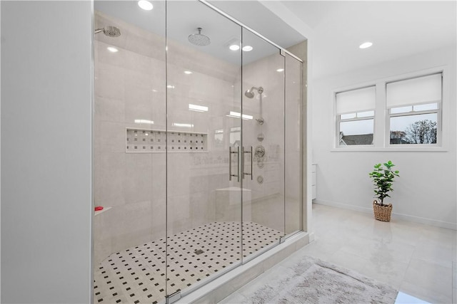 bathroom with recessed lighting, a shower stall, and baseboards