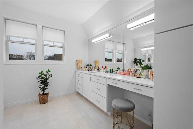 bathroom with vanity and baseboards