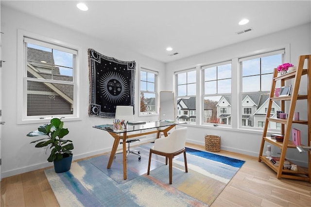 office featuring recessed lighting, visible vents, baseboards, and wood finished floors