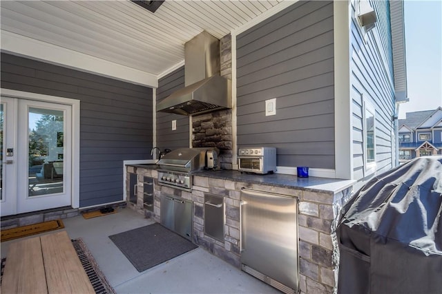 view of patio with area for grilling and an outdoor kitchen