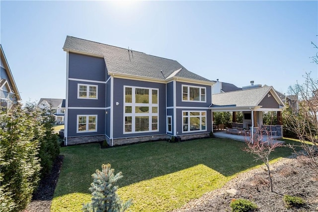 back of house with a lawn and a patio area