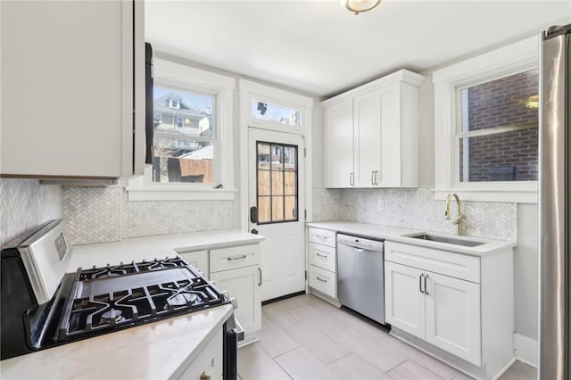 3234 Pinehurst Ave, Dormont, PA 15216 - kitchen with appliances with stainless steel finishes, a sink, light countertops, and tasteful backsplash