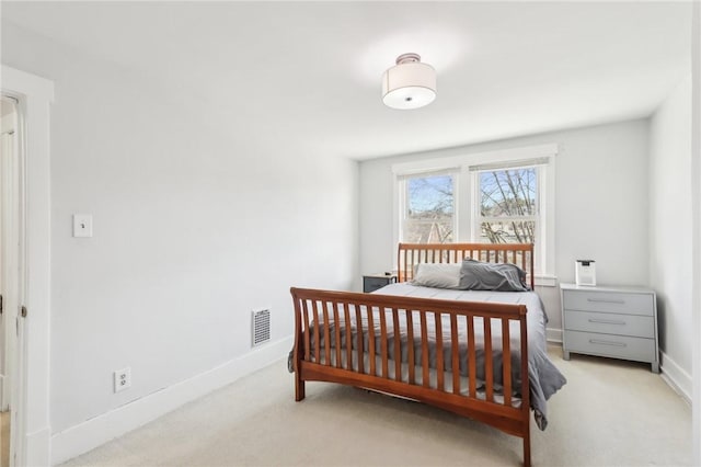 bedroom featuring visible vents, baseboards, and carpet