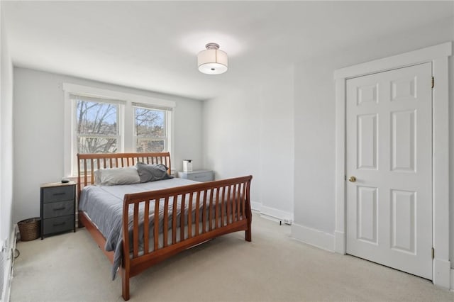 carpeted bedroom featuring baseboards