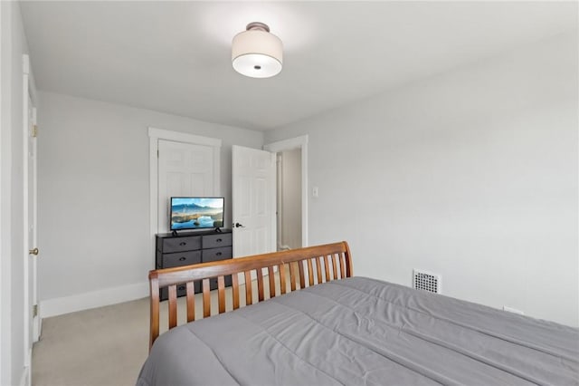 carpeted bedroom featuring visible vents and baseboards