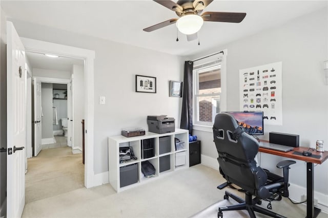 office area with baseboards, light colored carpet, and ceiling fan