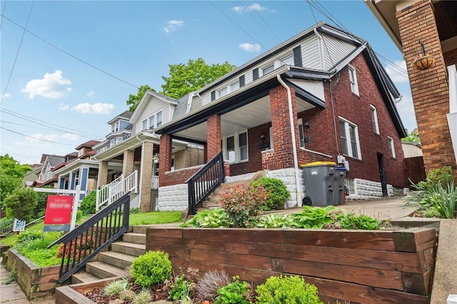 3234 Pinehurst Ave, Dormont, PA 15216 - view of front facade with a porch, brick siding, and stairway