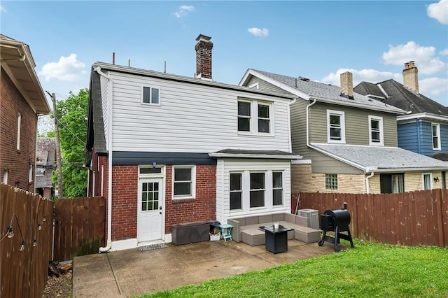 3234 Pinehurst Ave, Dormont, PA 15216 - back of house featuring brick siding, central AC, an outdoor hangout area, a patio, and a chimney
