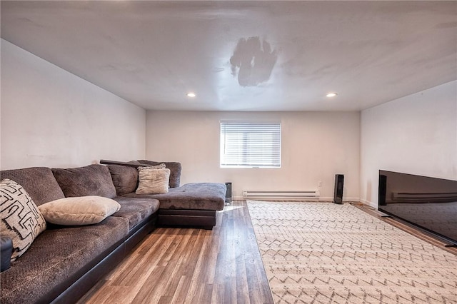 living room featuring a baseboard heating unit, recessed lighting, wood finished floors, and baseboards