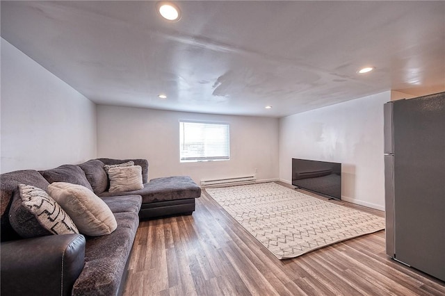 living area with recessed lighting, baseboards, baseboard heating, and wood finished floors