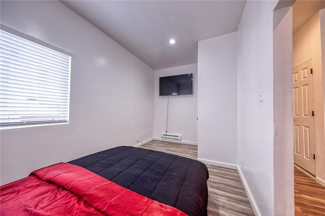 bedroom with recessed lighting, baseboards, and wood finished floors