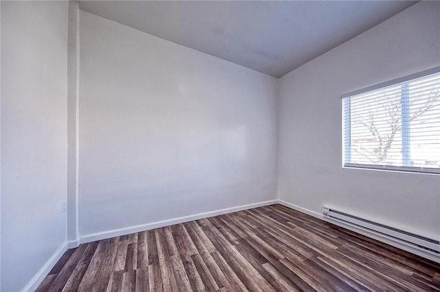 unfurnished room with baseboards, baseboard heating, and dark wood finished floors