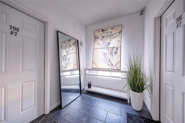 entryway featuring baseboards