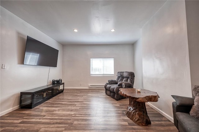 living area featuring recessed lighting, a baseboard radiator, baseboards, and wood finished floors