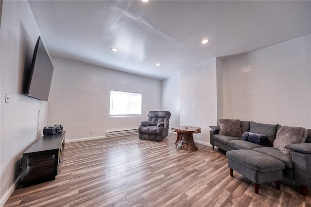 living room featuring baseboard heating, recessed lighting, baseboards, and wood finished floors