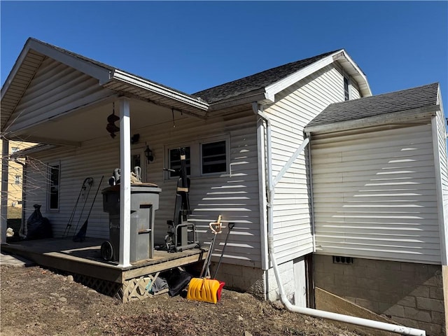 exterior space with roof with shingles