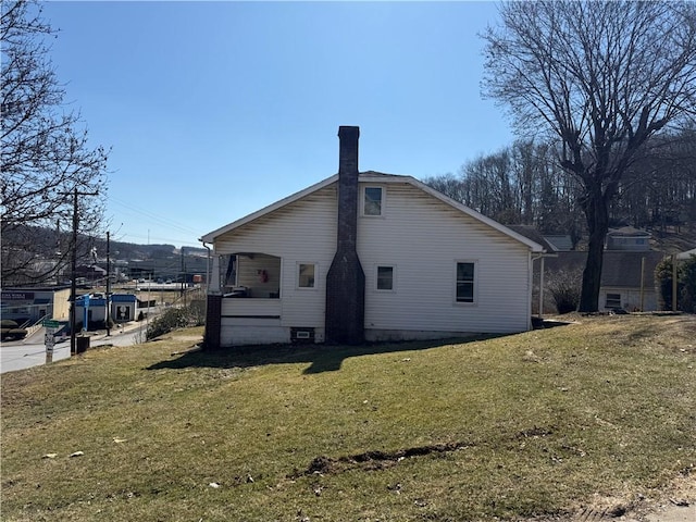 back of house featuring a yard