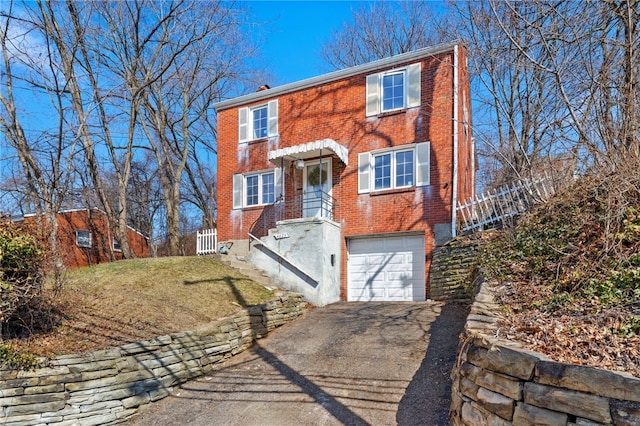 view of front of home featuring a garage, a front lawn, brick siding, and driveway