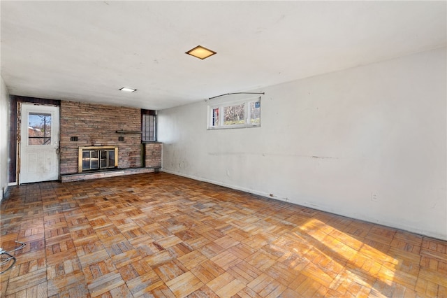 unfurnished living room with a brick fireplace