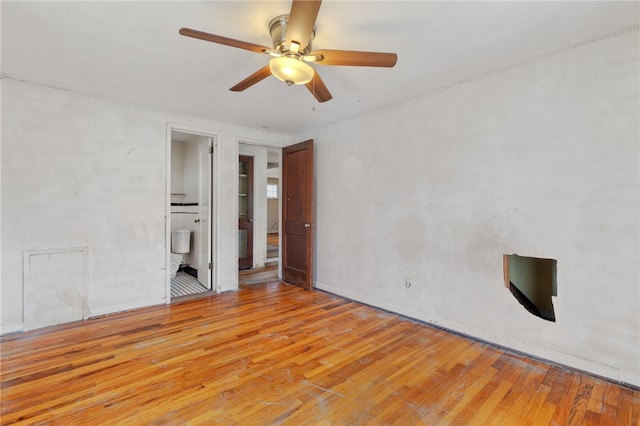 empty room featuring baseboards, light wood-type flooring, and a ceiling fan