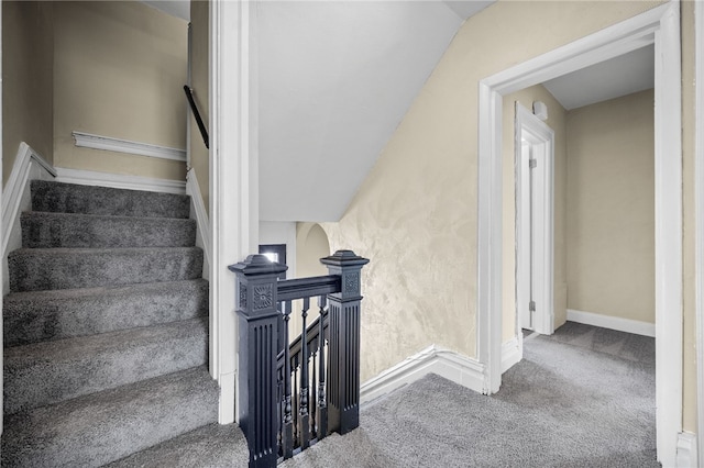 stairs featuring baseboards and carpet floors