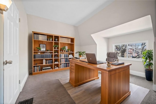 office with visible vents, baseboards, and light wood-type flooring