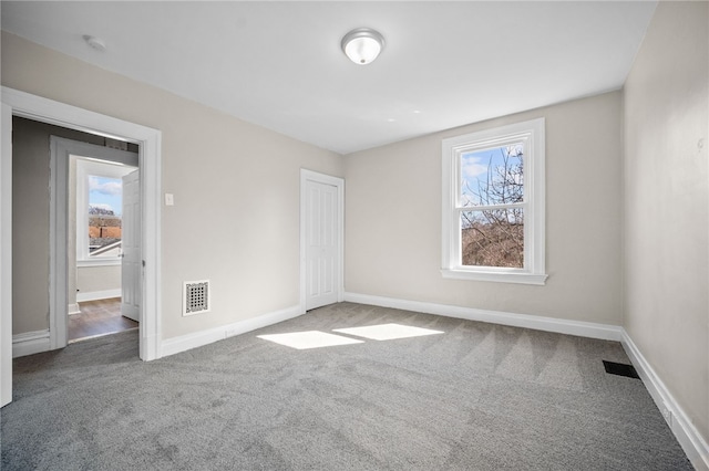 unfurnished bedroom featuring carpet flooring, baseboards, and visible vents