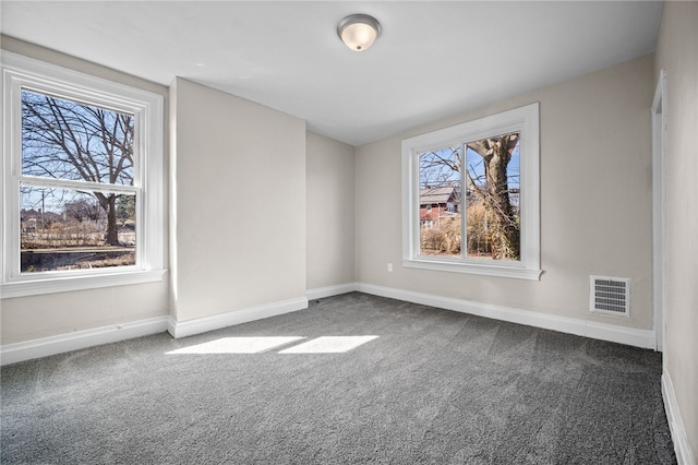 unfurnished room featuring carpet flooring, baseboards, and visible vents