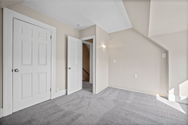 additional living space with lofted ceiling and carpet floors