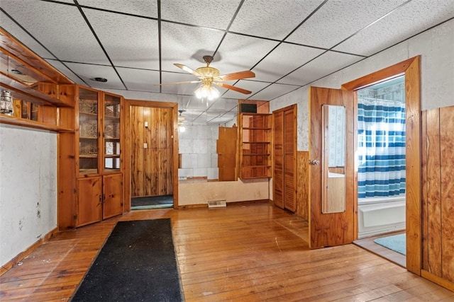 entrance foyer with a paneled ceiling, visible vents, wood-type flooring, and a ceiling fan