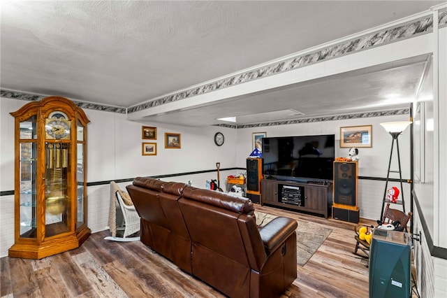 living area with wood finished floors and a textured ceiling