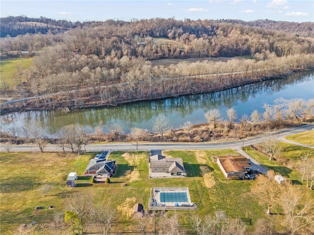 drone / aerial view with a water view and a wooded view